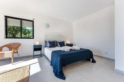 a bedroom with a bed with two towels on it at Casa Federica by Algarve Holidays in Santa Bárbara de Nexe