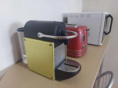 a coffee maker sitting on top of a table at Villa Duarte in Albufeira