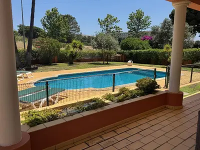 a swimming pool with a fence around it at Palm Villa in Albufeira