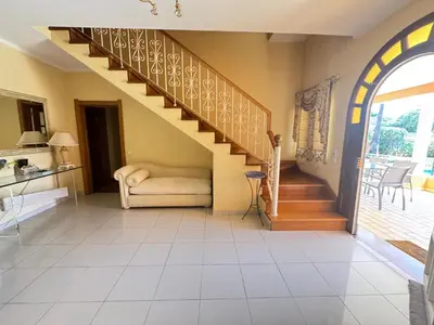 a living room with a staircase and a couch at Palm Villa in Albufeira