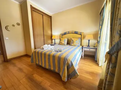 a bedroom with a bed with two towels on it at Palm Villa in Albufeira
