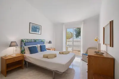 a bedroom with a large bed with blue pillows at Sail Golf Vilamoura V3 in Quarteira