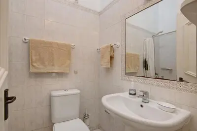 a bathroom with a toilet and a sink and a mirror at Sail Golf Vilamoura V3 in Quarteira