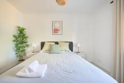 a bedroom with a large bed with towels on it at 2 Bedroom by Quarteira Beach in Quarteira