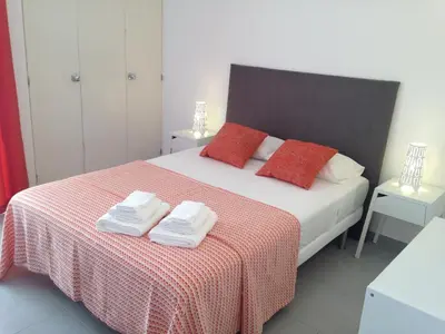 a bedroom with a bed with two towels on it at Casa Vila Magna in Albufeira