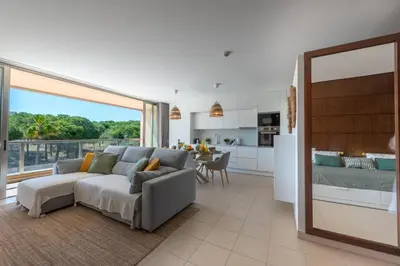 a living room with a couch and a kitchen at Herdade dos Salgados in Guia