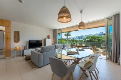 a living room with a table and a couch at Herdade dos Salgados in Guia