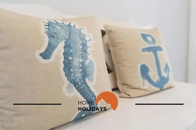 a seahorse pillow and a throw pillow with the words home holidays at #283 Palmeira Gale by Home Holidays in Galé