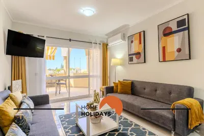 a living room with a couch and a tv at #283 Palmeira Gale by Home Holidays in Galé
