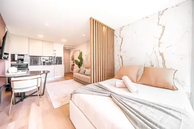 a living room with a bed and a kitchen at Downtown Luxury Studio - Faro in Faro