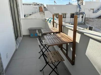 a kitchen and dining room with a table and chairs at Casa aOrta Apartments in Faro