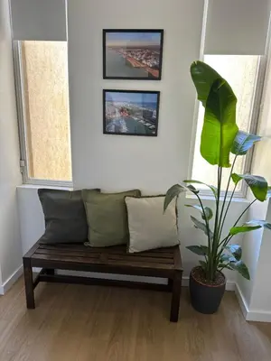 a bench in a living room with a plant at Vilamoura Living 106 in Quarteira