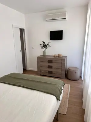 a bedroom with a bed and a tv on a wall at Vilamoura Living 106 in Quarteira