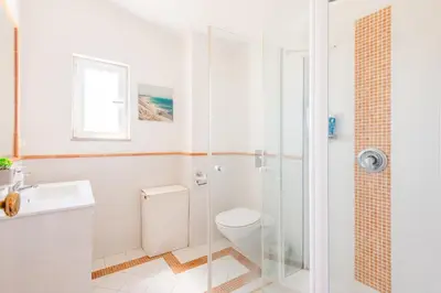a bathroom with a shower and a toilet and a sink at Vale do Lobo Apartment D in Vale do Lobo
