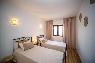 a bedroom with two beds and a window at Apartamento JADA in Albufeira