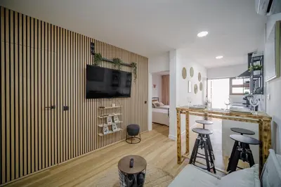 a living room with a tv on a wall at Apartamento JADA in Albufeira