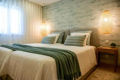 two twin beds in a room with a window at Luxury Garden House Apartment - Golf & Tennis Court & Pools in Albufeira