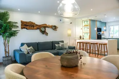 a living room with a blue couch and a table at Luxury Garden House Apartment - Golf & Tennis Court & Pools in Albufeira