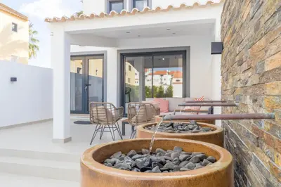 a bedroom with a large bed with white sheets and pillows at Casa Milea - Vilamoura Marina in Vilamoura