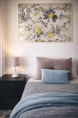 a bedroom with a bed with a painting on the wall at Albufeira New House in Albufeira