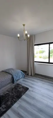 a bedroom with a bed and a large window at Albufeira New House in Albufeira