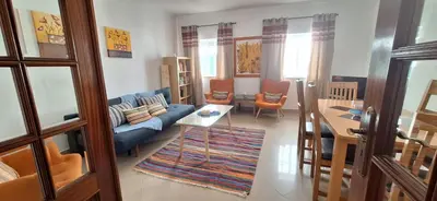 a living room with a couch and a table at Manu's Place in Albufeira