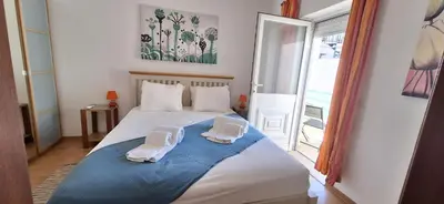a bedroom with a bed with two towels on it at Manu's Place in Albufeira