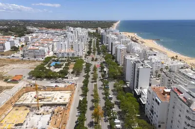 an aerial view of a city with a beach and buildings at Terracos de Quarteira II Pearl by Real Properties in Quarteira