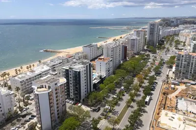 an aerial view of a city and the beach at Terracos de Quarteira II Pearl by Real Properties in Quarteira
