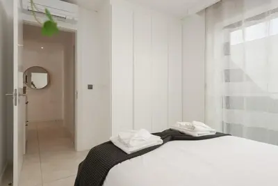 a bedroom with a bed with two towels on it at Terracos de Quarteira I Aqua by Real Properties in Quarteira