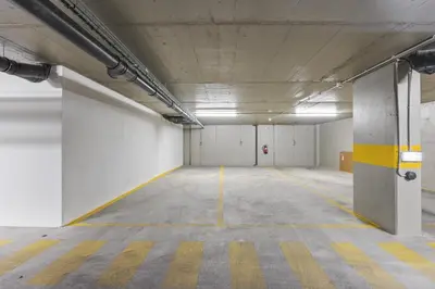 an empty parking garage with white walls and yellow stripes at Terracos de Quarteira I Aqua by Real Properties in Quarteira