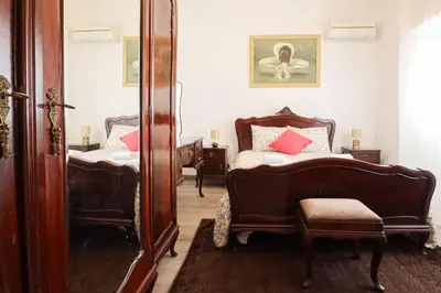 a bedroom with two beds and a mirror at Casa Bacalhau - Tunes - Jacuzzi - BY BEDZY in Tunes