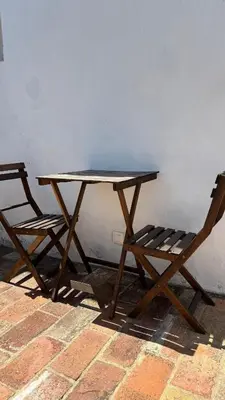 a stone retaining wall with a bench on a brick floor at Laranjeira 1 by AlmaAlgarvia in Santa Bárbara de Nexe