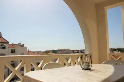 a table on a balcony with a view of the city at Alta Oura 2 in Albufeira