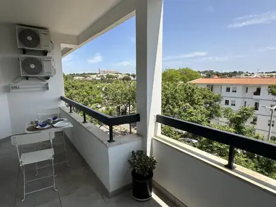 a balcony with a view of a city at Âncora Mar by FHR in Quarteira