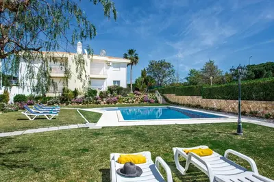 a backyard with a swimming pool and a house at Apartment 1A Gale Garden by Algarve Villa Holidays in Albufeira