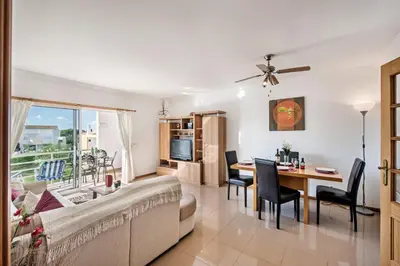 a living room with a couch and a table at Apartment 1A Gale Garden by Algarve Villa Holidays in Albufeira