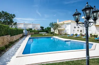 a swimming pool in the yard of a house at Apartment 1A Gale Garden by Algarve Villa Holidays in Albufeira