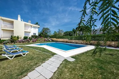 a swimming pool in the yard of a house at Apartment 1A Gale Garden by Algarve Villa Holidays in Albufeira