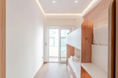 a bathroom with a white toilet and a sink at Sandora Breeze by Seareen in Albufeira