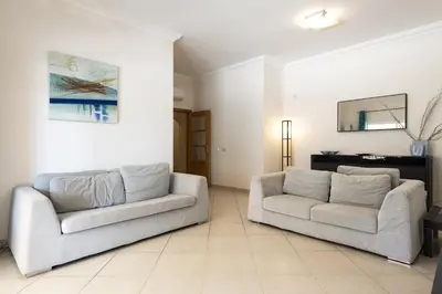 a living room with two white couches and a mirror at Praia Village III - Peaceful condominium by HD in Quarteira