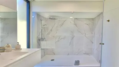 a white bathroom with a shower and a sink at Villa Rimah, Sunny Algarve, Entire Home 
