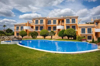 a large house with a swimming pool in front of it at Rosemary Apartment in Olhos de Água