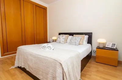 a bedroom with a bed with two towels on it at Rosemary Apartment in Olhos de Água