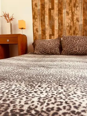 a bedroom with a bed with a cheetah print at Marina Albufeira Best Apartment in Albufeira