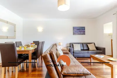 a living room with a couch and a table at #327 Corcovada 43 Vista Piscina by Home Holidays in Albufeira