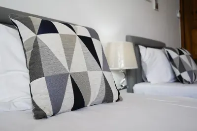 a bed with a black and white pillow on it at #326 Vista Mar by Home Holidays in Albufeira
