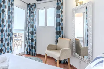 a bedroom with a mirror and a chair at #326 Vista Mar by Home Holidays in Albufeira