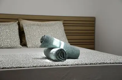 a blue sock sitting on a bed with pillows at Train Station Guesthouse in Faro