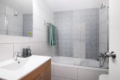 a bathroom with a sink and a tub and a shower at The Oura Stay in Albufeira